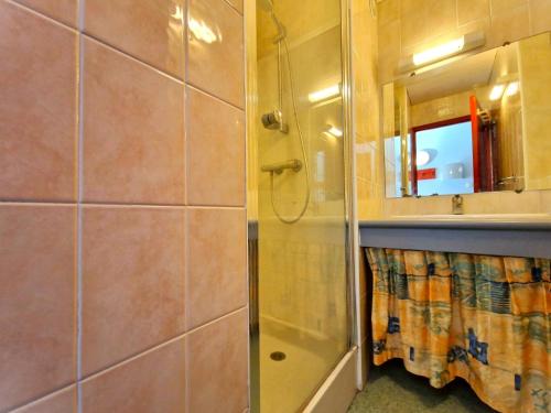 a bathroom with a shower and a sink and a mirror at B4 Vue Montagnes Piscine in Souraïde