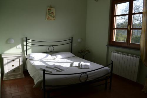 a bedroom with a bed with towels on it at Agriturismo La Selva in Aulla