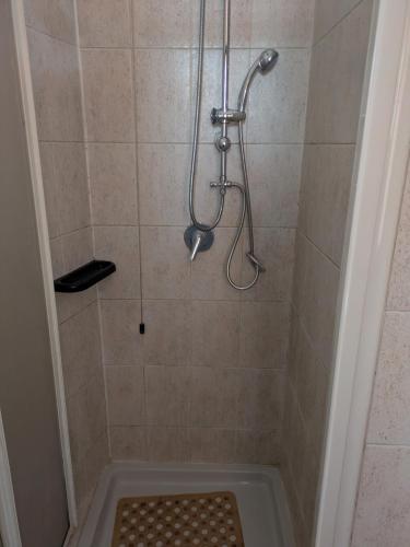 a shower with a shower head and a shower at Corte Meneghina-short stays in Buscate