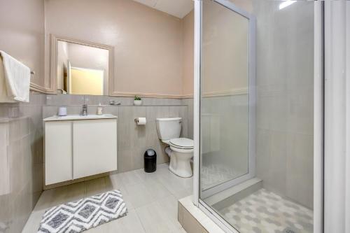 a bathroom with a shower and a toilet and a sink at Tashy Luxury 2 bedroomed apartment in Johannesburg