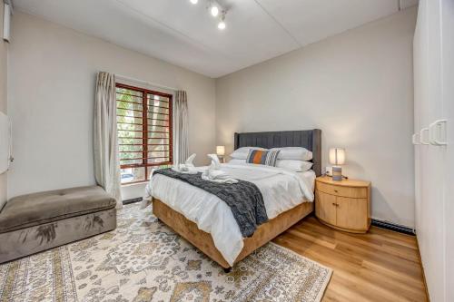 a bedroom with a large bed and a window at Tashy Luxury 2 bedroomed apartment in Johannesburg