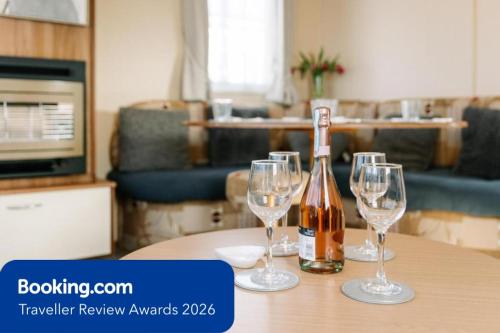 a bottle of wine and two wine glasses on a table at Island Retreat in Sandown
