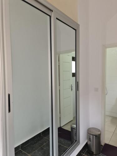a mirrored medicine cabinet in a bathroom with a mirror at ADM HOTEL Grand-Lahou in Grand-Lahou