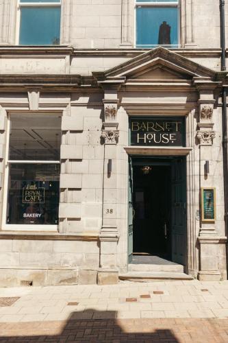 a facade of a building with a barber house at Barnet House Serviced Apartments in Dunfermline