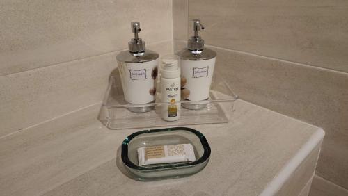 two bottles ofodorizers sitting on a counter in a bathroom at Il Loft di Pieve in Città della Pieve