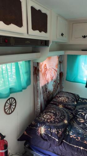 a bedroom with a bed in a rv at Roulotte individuelle dans le maquis Corse in Pianottoli-Caldarello