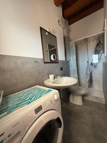 a washing machine in a bathroom with a sink at Terrazza delle mura in Cefalù