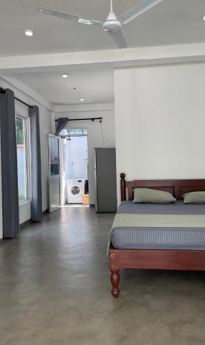 a bedroom with a bed and a door to a bathroom at Hideaway in Bentota