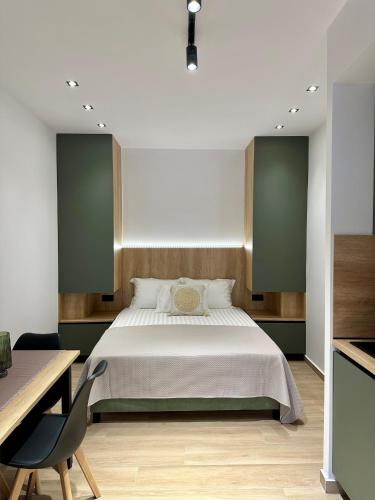 a bedroom with a large bed and a desk at Nido Estivo 2 in Nea Skioni