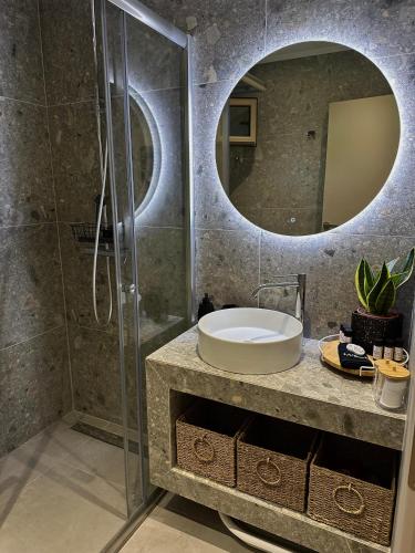 a bathroom with a sink and a shower at Nido Estivo 2 in Nea Skioni