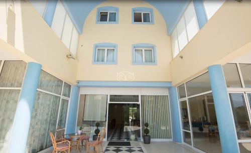 a building with a table and chairs in front of it at Eleni Palace in Amoudara Herakliou