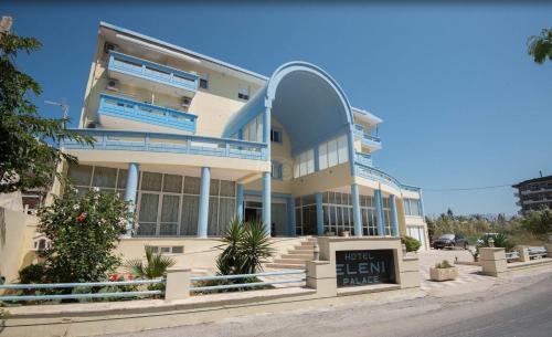 a large building with a sign in front of it at Eleni Palace in Amoudara Herakliou