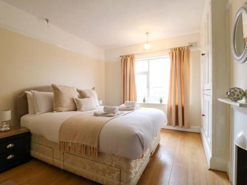 a bedroom with a large bed and a window at 5 Wallace Road in Loughborough