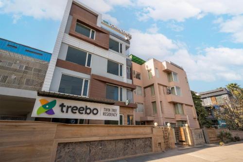 a treeoco building with a sign in front of it at Treebo Twin Tree Residency in Gurgaon