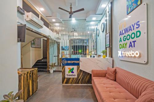 a lobby with a couch and a sign that reads always a good day at n at Treebo Twin Tree Residency in Gurgaon