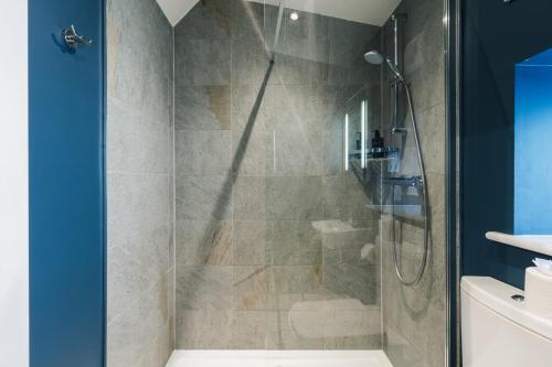 a shower with a glass door in a bathroom at The Lookout in Ilkley