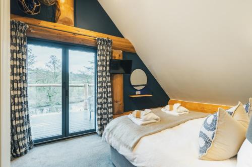 a bedroom with a bed and a large window at The Lookout in Ilkley