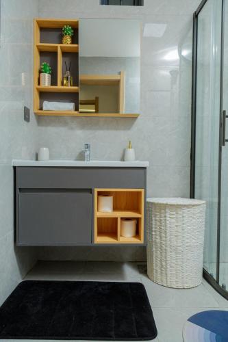 a bathroom with a sink and a mirror at Riara One Residency in Gatunga