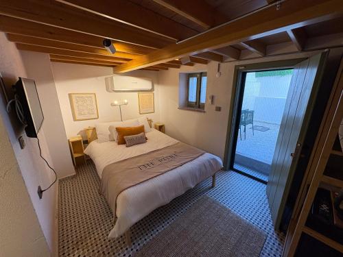 a bedroom with a bed and a sliding glass door at Macaron The Pure Guest Houses in Ayvalık