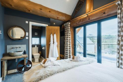 a bedroom with a large bed and a bathroom at Apres Ski in Ilkley