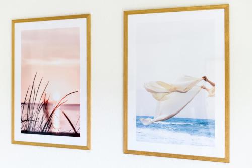two framed photographs hanging on a wall at Ferienwohnung Sternstunde in Bensersiel