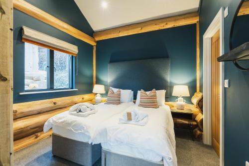 a bedroom with a large bed with white sheets at The Farmhouse in Ilkley