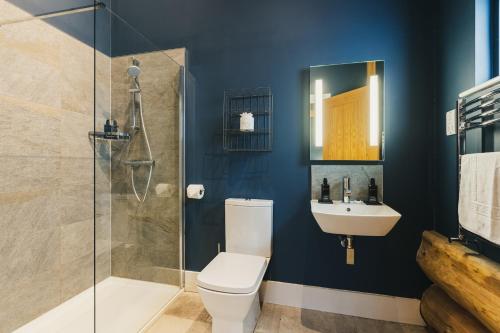a bathroom with a toilet and a sink and a shower at The Farmhouse in Ilkley