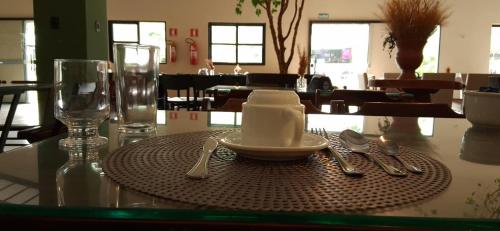 a table with a plate of food on a table at Pousada Casa de Naná in Palmas