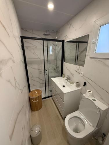 a white bathroom with a toilet and a sink at Independent Apartment At Villa Noelia Benalmádena With Private Pool, Garden & Parking in Benalmádena