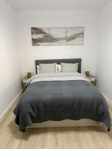 a bedroom with a large bed in a white room at Independent Apartment At Villa Noelia Benalmádena With Private Pool, Garden & Parking in Benalmádena