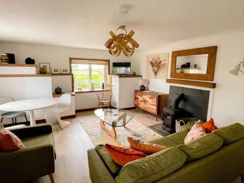a living room with a couch and a table at Evrabister, Shetland Islands in Mainland