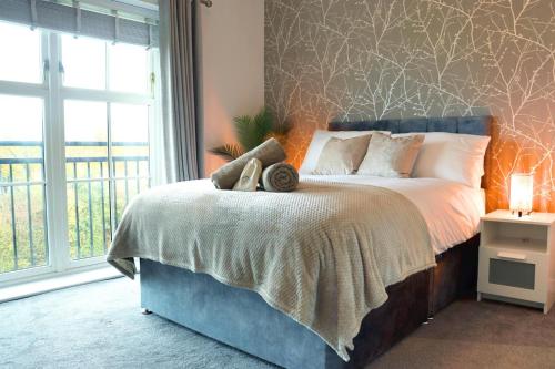 a bedroom with a bed with a large window at The Contractor Condo - Underground Parking in Aylesbury