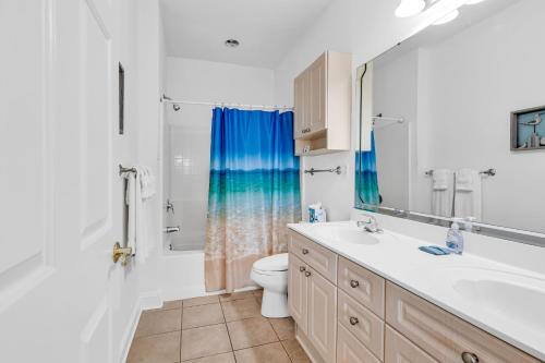 a bathroom with a sink and a toilet and a shower at Myrtlewood by Monarch Rentals in Myrtle Beach