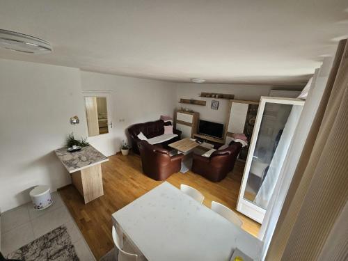 a living room with a couch and a table and chairs at Airport Apartment in Surčin