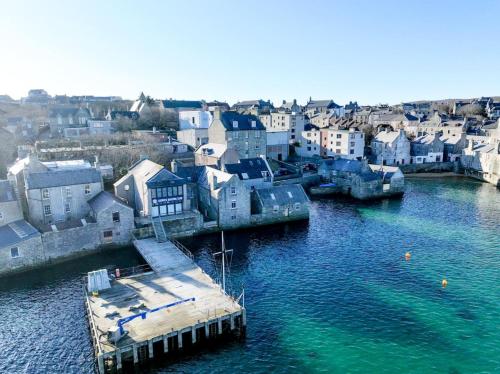 an aerial view of a town on the water at The Seadoor, Shetland Islands in Lerwick