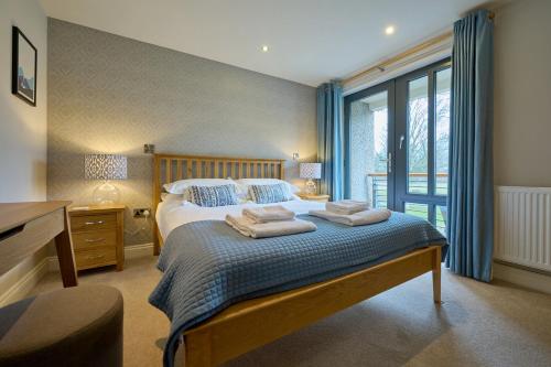 a bedroom with a bed with towels on it at Riverside Park 3 in Keswick