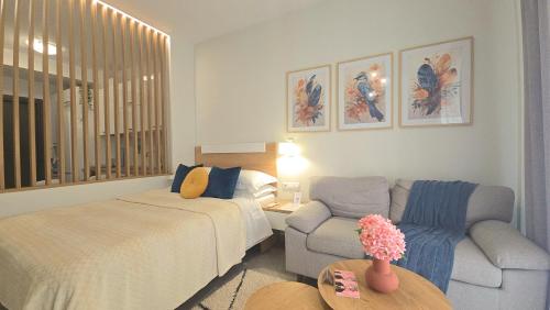 a living room with a bed and a couch at Alfa-Central Luxury Condo by Optimum Link in Katerini
