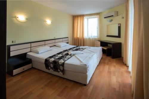a hotel room with a bed and a television at South Beach Hotel - New Management and Free Beach Access in Tsarevo