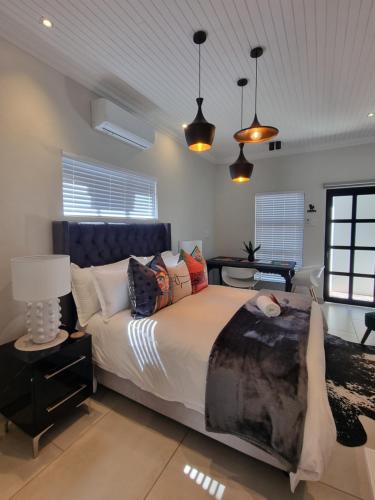 a bedroom with a large bed in a room at Picasso Dreams in Kimberley
