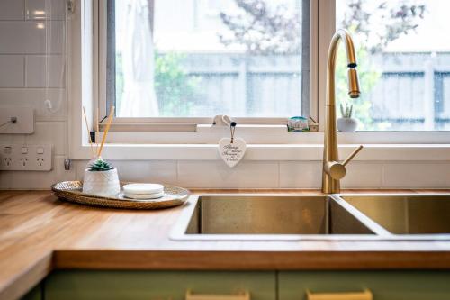 a kitchen counter with a sink and a window at Fireplace & Winter Swells, 800m to the beach in Ocean Grove