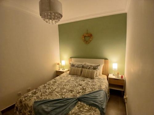 a bedroom with a bed and two night stands with lamps at RJ Summer in Sagres