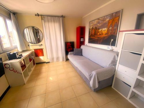 a living room with a couch and a mirror at Attico Sant'Anna - Silent Bay Apartments in Sestri Levante