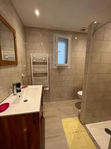 a bathroom with a sink and a toilet at Loue rez de maison 3mn de la plage in Canly