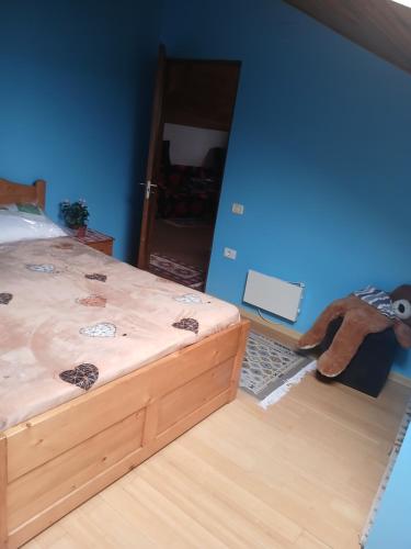 a bedroom with a bed and a stuffed animal on the floor at Cărăbuș in Tuzla