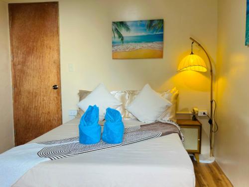 a bedroom with a bed with blue bags on it at El Nido's View in El Nido