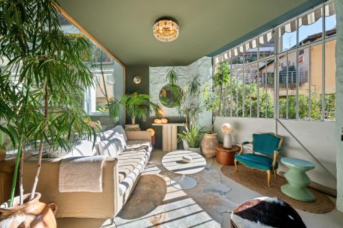 a living room filled with furniture and plants at Maison Nice - Plage 300m - Parking in Nice