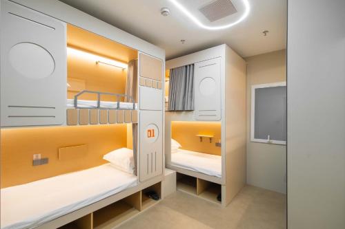 a small room with two bunk beds in it at SilMiCore Hostel in Shanghai