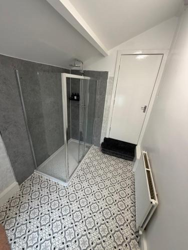 a shower with a glass door in a bathroom at The Victoria Bar & Hotel in Wakefield
