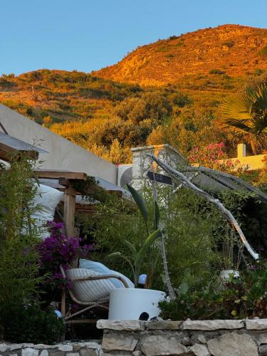a garden with a water fountain in the middle of a hill at Kallmi View - Nature Retreat on the Albanian Adriatic Coast in Durrës