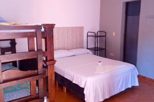 a small bedroom with a bed with a candle on it at Hotel Pisci Stars Sra in Saravena